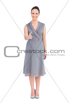 Cheerful elegant brunette in classy dress posing