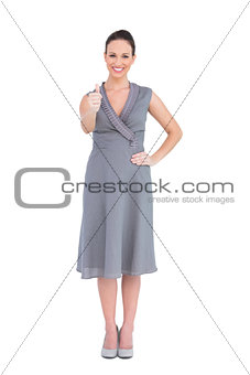 Cheerful elegant woman in classy dress thumb up