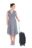 Cheerful gorgeous woman posing with her suitcase