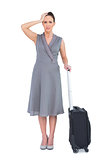 Worried gorgeous woman with suitcase posing