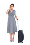 Gorgeous woman with suitcase suffering from headache