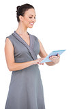 Smiling gorgeous woman holding digital tablet