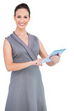 Cheerful gorgeous woman holding digital tablet