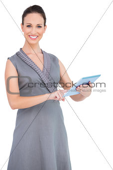 Cheerful gorgeous woman holding digital tablet
