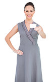 Smiling seductive woman holding business card