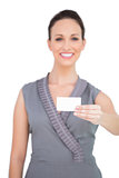 Happy seductive woman holding business card
