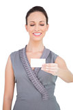 Smiling seductive model holding business card