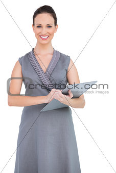 Smiling seductive model holding clipboard