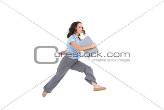 Cheerful classy businesswoman jumping while holding clipboard