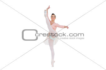 Smiling gorgeous ballerina rising her leg