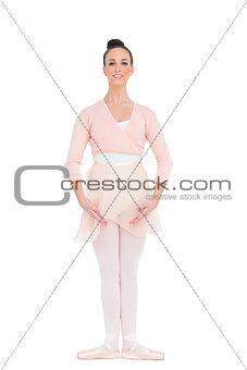 Cheerful gorgeous ballerina standing in a pose