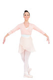 Smiling attractive ballerina standing in a pose