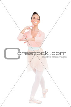 Cheerful attractive ballerina standing in a pose