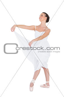 Happy young ballet dancer posing