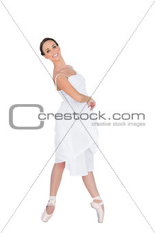 Smiling young ballet dancer standing on her tiptoes