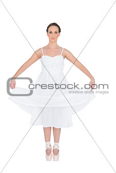 Peaceful young ballet dancer standing on her tiptoes