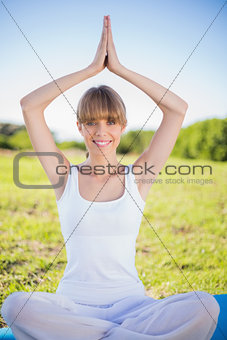 Happy natural young woman doing yoga