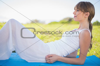 Content young woman relaxing on her mat