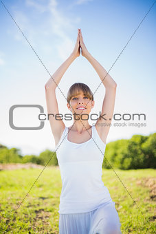 Cheerful young woman exercising outside