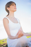 Peaceful young woman relaxing in yoga position