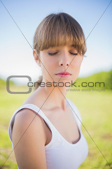 Pensive young woman posing outside