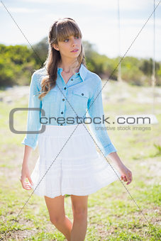 Pensive young woman posing next to a swing