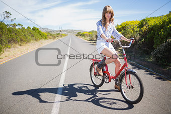 Pretty young model riding bike