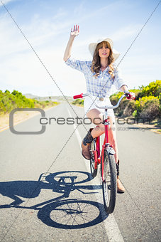 Pretty model on her bike making gesture