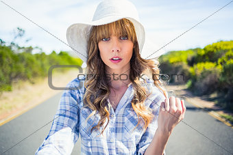 Trendy young woman posing while walking on the road