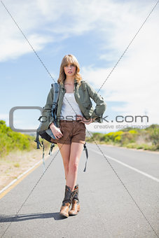 Sexy blonde woman posing while hitchhiking