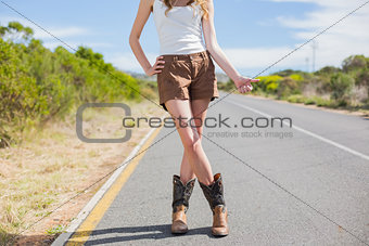 Natural attractive woman posing while hitchhiking