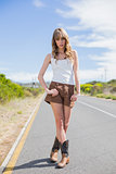 Attractive woman posing while hitchhiking