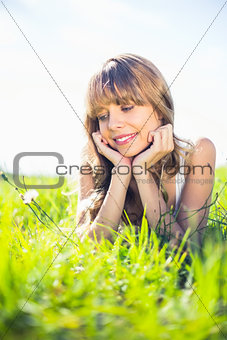 Pretty blonde woman admiring flowers