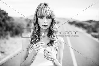 Black and white photograph of natural blonde holding flower