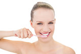 Content pretty blonde model brushing her teeth