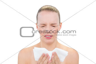 Frowning pretty blonde model sneezing