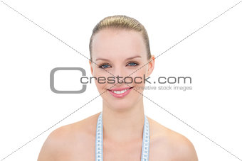 Happy pretty blonde model wearing a measuring tape around her neck