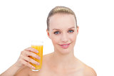 Cheerful pretty blonde model holding a glass of orange juice
