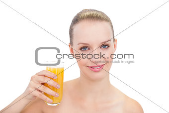 Cheerful pretty blonde model holding a glass of orange juice