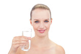 Amused pretty blonde model holding a glass of water