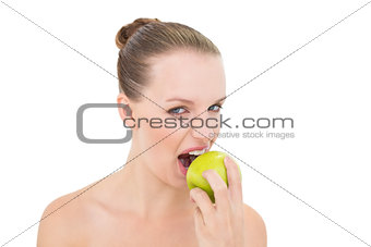 Pretty blonde model eating an apple