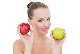 Smiling pretty blonde model holding two apples