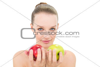 Cute blonde model offering two apples