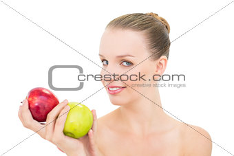 Cheerful pretty blonde model holding two apples