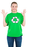 Surprised pretty environmental activist raising her hands