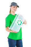 Cheerful pretty environmental activist holding a recycling box