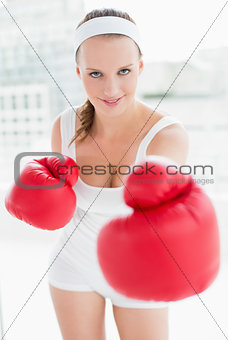 Relaxed pretty sportswoman boxing the camera