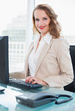 Happy pretty businesswoman using a computer