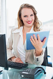 Calm pretty businesswoman using a tablet pc
