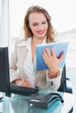 Concentrated pretty businesswoman using a tablet pc